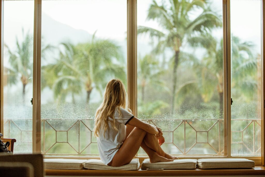 Woman sitting in front of the window
